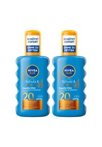 Two bottles of NIVEA Sun sunscreen, blue plastic, contoured shape, yellow caps, and labels featuring text about skin protection and tanning.