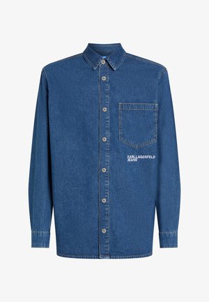 Sötétkék farmering gombos elülső résszel, gallérral, egyetlen mellzsebbel és fehér "KARL LAGERFELD JEANS" hímzéssel.