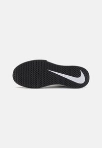 Nikeova cipela s posebnom crnom gumom na potplatu, koja sadrži bijeli Nike swoosh logo i jedinstveni uzorak na gaznom sloju za bolje prianjanje.