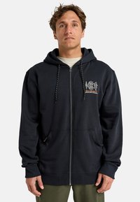 Navy blauwe zip-up hoodie met een trekkoordkap, voorzakken, geribbelde manchetten en geborduurde grafische ontwerpelementen op de borst. Zachte stofstructuur.
