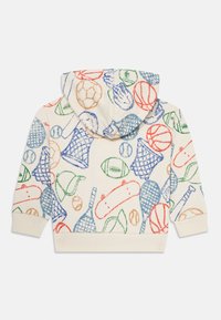 Felpa color crema con doodles sportivi colorati, tra cui palloni da basket, palloni da football, racchette da tennis, palline da baseball e reti.