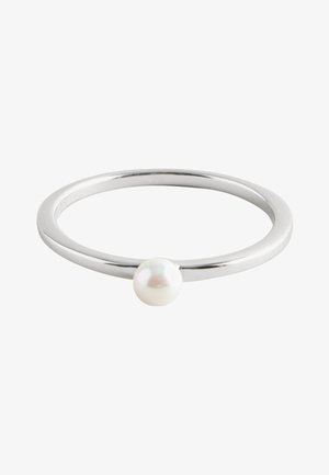 Thin silver ring with a single small white pearl centered on the band against a white background.