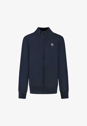 Marineblauwe gebreide trui met hoge kraag, volledige ritssluiting aan de voorkant, geribbelde manchetten en zoom, met een cirkelvormig logo op de linkerkant van de borst.