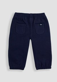 Marineblå børnesweatpants lavet af blødt stof, med elastisk talje, to baglommer og ribbede manchetter.