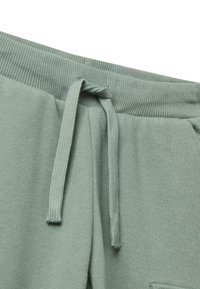 Groene sweatpants met een geribde tailleband en verstelbare trekkoord. Zachte stof met zijzakken. Casual ontwerp.