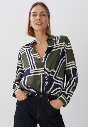 Button-up shirt made of smooth fabric featuring a geometric pattern in olive green, navy blue, and white. Classic collar and long sleeves.