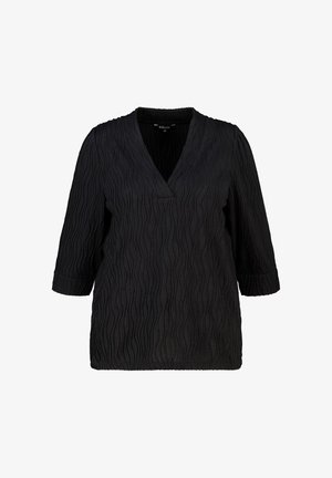 Blouse noire texturée avec manches 3/4, décolleté en V et manches retroussées, taille moyenne, présentée sur un fond blanc.