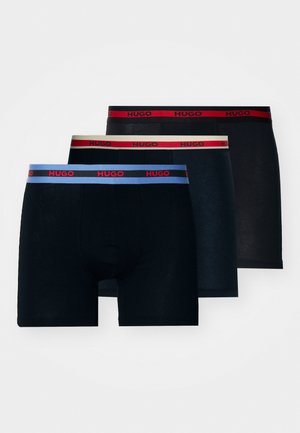 Mustad mustrid mustriga elastse vööga. Ühel paaril on sinine, teisel punane ja kolmandal neutraalne beež kontrastne vöö.