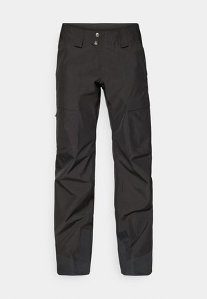 Black ski pants made of nylon, featuring a straight design, two front pockets, and reinforced ankles with textured detailing.