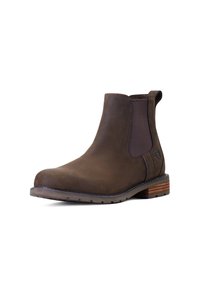 Bruine leren Chelsea boot met elastische zijpanelen, ronde neus en gestapelde houten hak. Heeft subtiele stikselaccenten.