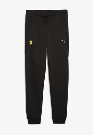 Pantalons de sport noirs en tissu doux, avec poches latérales zippées, une taille élastique et des logos de Ferrari et Puma.