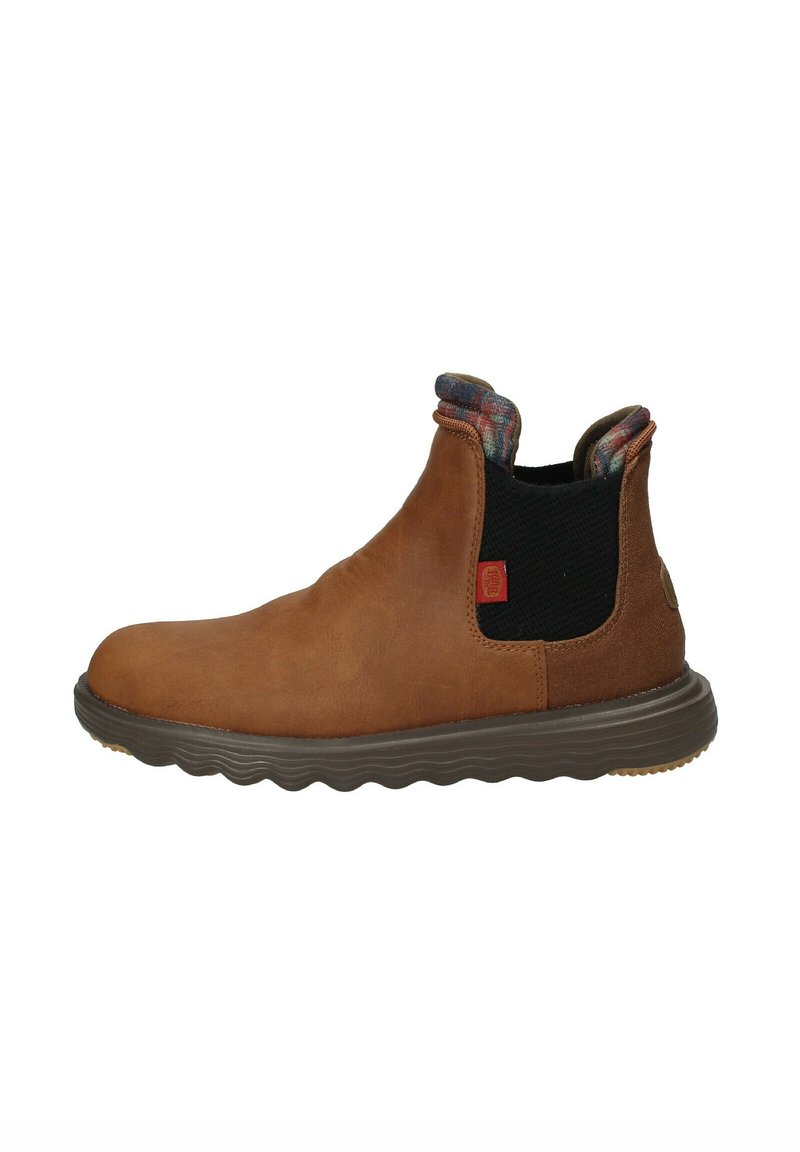 Bottines en cuir brun avec panneaux latéraux en elastique, semelle en caoutchouc texturé et doublure à carreaux au col. Comprend des détails cousus.