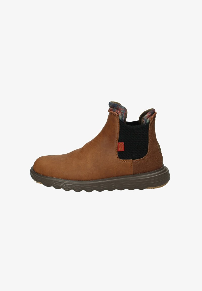 Bottines en cuir brun avec panneaux latéraux en elastique, semelle en caoutchouc texturé et doublure à carreaux au col. Comprend des détails cousus.