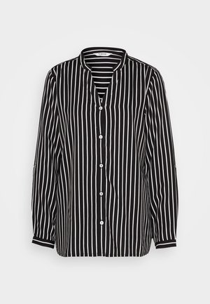 Juoda ir balta dryžuota marškiniai su V formos iškirpte, ilgomis rankovėmis ir laisvu kirpimu. Yra baltos knopkės ir kontrastingos rankogaliai.