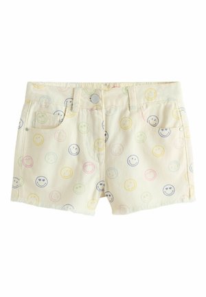 Cream-colored denim shorts with multicolored smiley face prints, front pockets, belt loops, and a button closure.