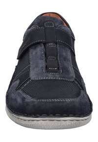 Black shoe featuring a mix of suede and mesh materials, with a Velcro strap, gray stitching, and a textured sole.