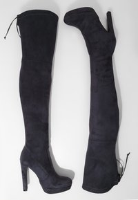 Stivali alti in suede nero con tacco alto, zeppa frontale e cordoncino regolabile in cima, texture liscia e design aderente.