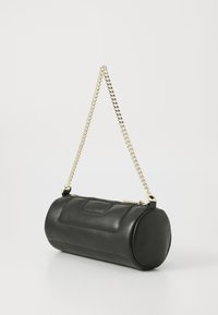 Black leather cylindrical handbag with a golden chain strap, featuring a zip closure and a smooth texture, minimalistic design with a flat front.