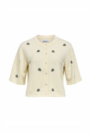 Krém színű, rövid ujjú, gombos kardigán fekete hímzett rózsamintákkal, egyenletesen elosztva az elején és az ujjakon.