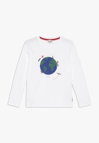 Camiseta de manga larga blanca con un gráfico de la Tierra en azul y verde, rodeado de íconos de viaje, con un acento rojo en el cuello.