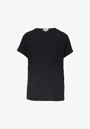 Haut noir à manches courtes en tissu texturé avec un motif en vagues. Encolure ronde et coupe ample, avec des fentes sur les côtés pour plus de confort.