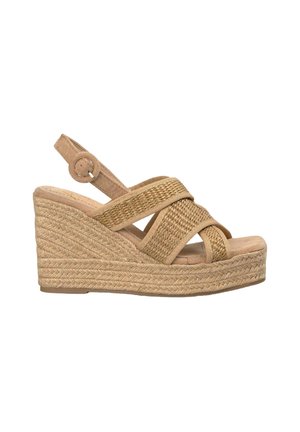 Wedge sandal in tan suede with woven cross straps, adjustable ankle strap, and braided jute platform sole. Textured detailing on straps.