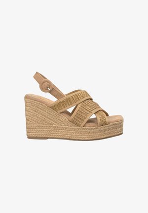Wedge sandal in tan suede with woven cross straps, adjustable ankle strap, and braided jute platform sole. Textured detailing on straps.