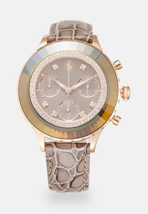 Rose gold chronograph watch with a brown crocodile-patterned leather strap, crystal accents, and a textured dial with three sub-dials.