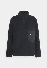 Czarny pulower z polaru z wysokim kołnierzem, czterema guzikami i kieszenią na piersi na zamek błyskawiczny z ciemnym materiałowym akcentem.