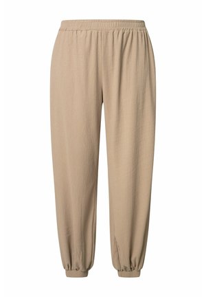 Lässige beige Textilhose mit elastischem Bund und gesammelten elastischen Bündchen, entworfen für den Freizeitgebrauch.