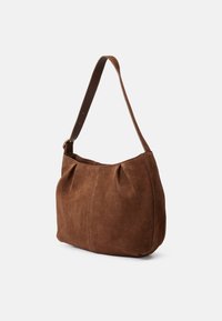 Brown suede handbag with a soft texture, rounded shape, and a single brown strap. Features pleated detailing on the front.