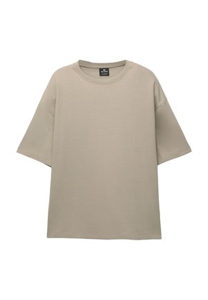 Tricou oversized bej, fabricat dintr-un material moale, având mâneci scurte și un guler clasic. Design simplu, fără modele sau accente.