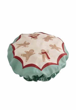 Round fabric cover with elastic edge, decorated with gingerbread men and candy canes on a cream and green background with red trim.