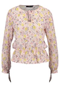 Blusa floreale con maniche lunghe, sfondo rosa, fiori gialli e dettagli curati. Presenta una vita a peplo arricciata e polsini con laccio.