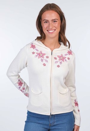 Cream-colored zip-up hoodie with floral embroidery in pink and purple. Features two front pockets and fitted cuffs. Soft texture.