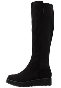 Zwarte laarzen tot de knie van suede met een glad textielpaneel, een dikke zool en een licht verhoogde wiggenhak. Heeft textuur aan de zijkanten.