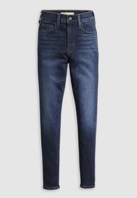 Tamno plave traperice uskog kroja, s visokim strukom, pet džepova i kontrastnim šavovima. Glatka denim tekstura i standardne petlje za remen.