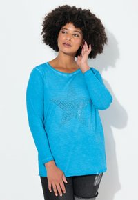 Blaues Langarmhemd aus weichem Stoff, mit einem großen Strassstern-Design auf der Vorderseite und einer lockeren Passform.