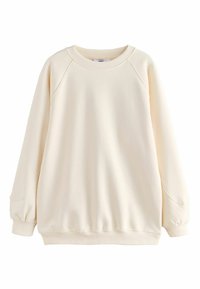 Lyscreme sweatshirt lavet af blødt stof. Har raglanærmer, ribbede manchetter og kant, med en afslappet pasform og glat overflade.