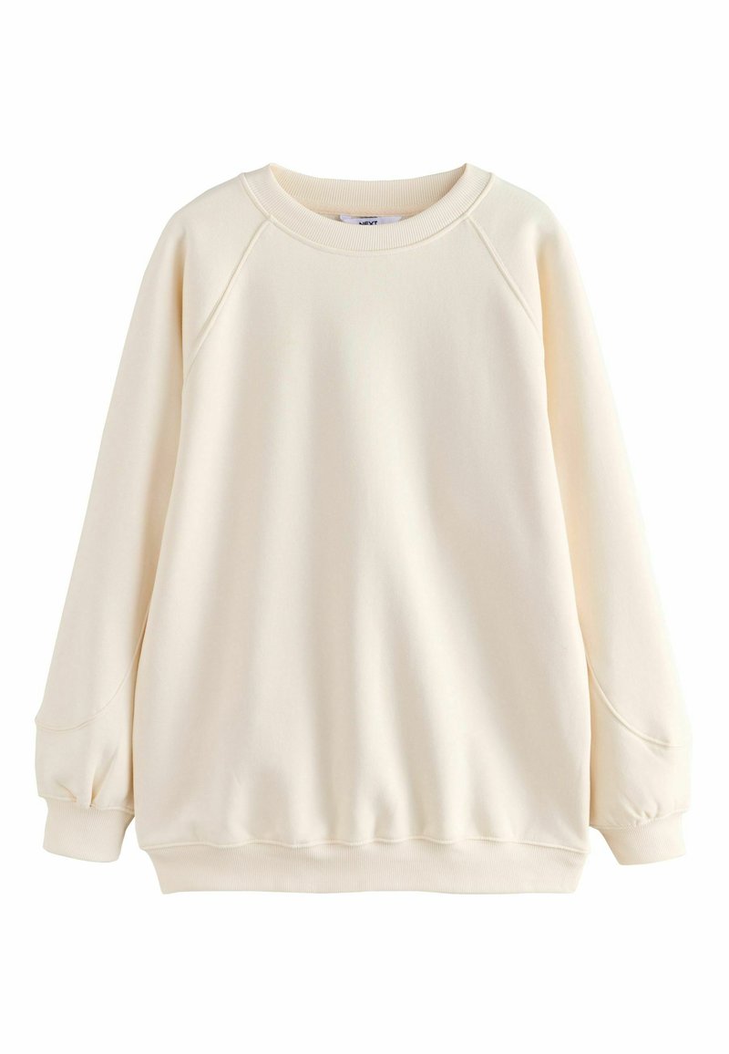 Lyscreme sweatshirt lavet af blødt stof. Har raglanærmer, ribbede manchetter og kant, med en afslappet pasform og glat overflade.