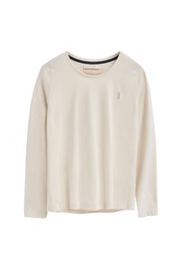 Helle beige Langarmbluse aus weichem Baumwollstoff. Mit rundem Ausschnitt und gesticktem Logo auf der linken Brust. Glatte Textur.