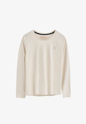 Camisa de manga larga de color beige claro, hecha de algodón suave. Presenta un cuello redondo y un logotipo bordado en el lado izquierdo del pecho. Textura suave.