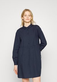 Vestido azul-marinho de manga longa com abertura para botões, gola de colarinho, cintura franzida e punhos elásticos. Tecido suave com um corte descontraído.