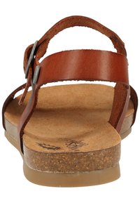 Sandal in pelle marrone con un design minimalista, dotata di cinturini regolabili e una soletta in sughero, completata da una leggera suola in gomma.