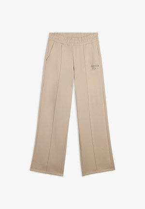 Pantaloni beige a gamba larga con vita elastica testurizzata, tasche laterali e logo ricamato "Freddy" sul lato sinistro frontale.