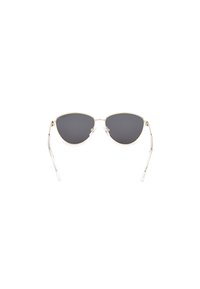 Ochelari de soare tip cat-eye cu lentile închise și cadru din metal aurit. Brațe din acetat transparent cu detalii subtile.