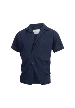 Camicetta navy a maniche corte in tessuto testurizzato, con chiusura a bottoni, colletto, taschino sul petto e un branding discreto sulla tasca.
