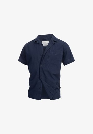 Chemise bleu marine à manches courtes en tissu texturé, avec un boutonnage sur le devant, un col, une poche poitrine et un logo subtil sur la poche.