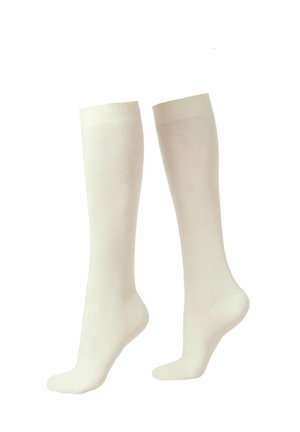 Wadenhohe Socken aus weichem, hellcremfarbenem Stoff mit glatter Textur und geripptem Oberband. Einfaches Design ohne sichtbare Muster oder Metallteile.