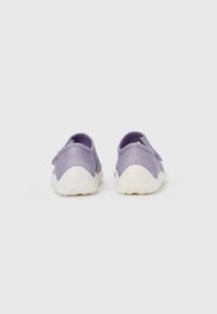 Purple fabric sneakers with white rubber soles, rounded shape, and a loop on the back for easy wear. Simple and seamless design.